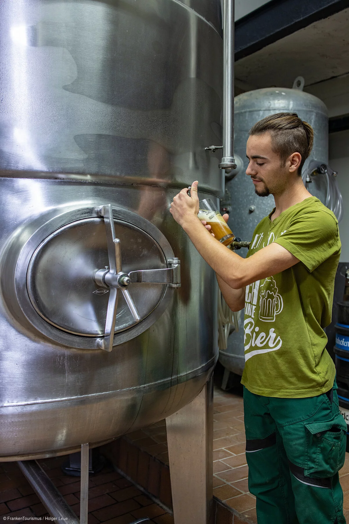 Brewery worker Tobias Bayer of Brauerei Ulrich Martin brewery, Schonungen Hausen, Franconia, Bavaria, Germany